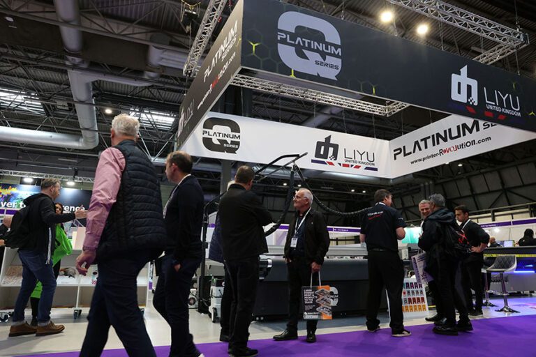 The Liyu UK stand at The Print Show 2023 with crowds in front of it and purple carpet
